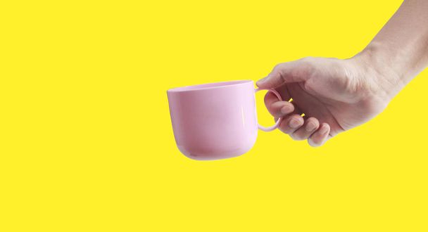 Hand holding plastic cup like a pouring - Photo, Image