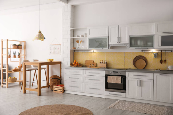 Modern kitchen interior with stylish wooden table - Foto, imagen