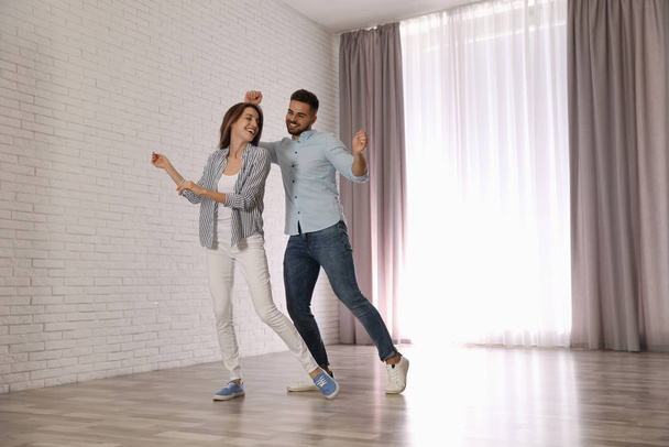 Lovely young couple dancing together at home - Foto, immagini