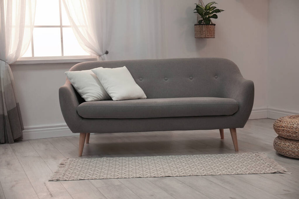 Modern comfortable sofa in stylish home interior - Fotó, kép