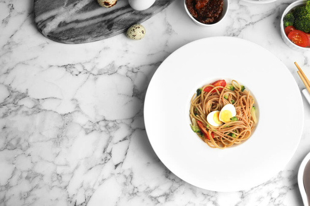 Tasty buckwheat noodles served on white marble table, flat lay. Space for text - Foto, Imagen