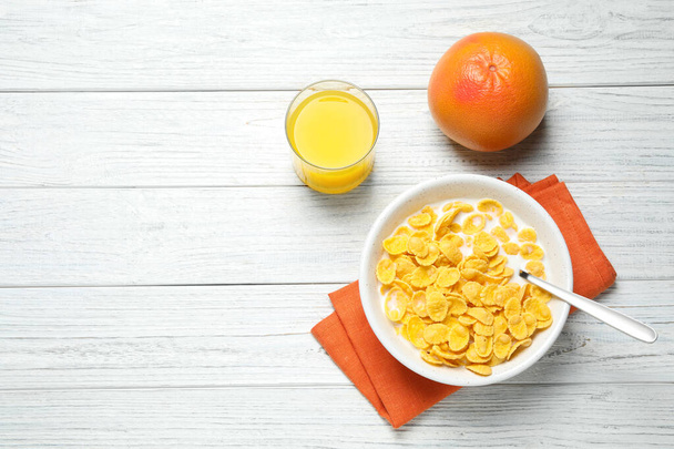 Flat lay composition with tasty corn flakes on white wooden table. Space for text - Foto, Imagen