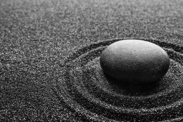 Black sand with stone and beautiful pattern. Zen concept - Фото, зображення