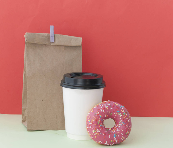round red glazed donut and paper cup with coffee - Photo, Image