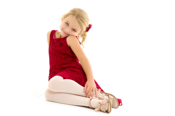 Little girl is sitting on the floor.The concept of a happy child - Photo, image