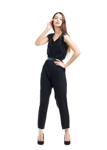 Full body, beautiful brunette woman in a black blouse and pants - 写真・画像