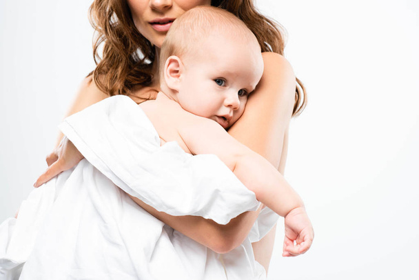 cropped view of nude mother holding baby, isolated on white - Foto, Imagem