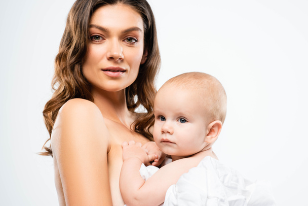 portrait of nude mother holding baby boy, isolated on white - Fotó, kép