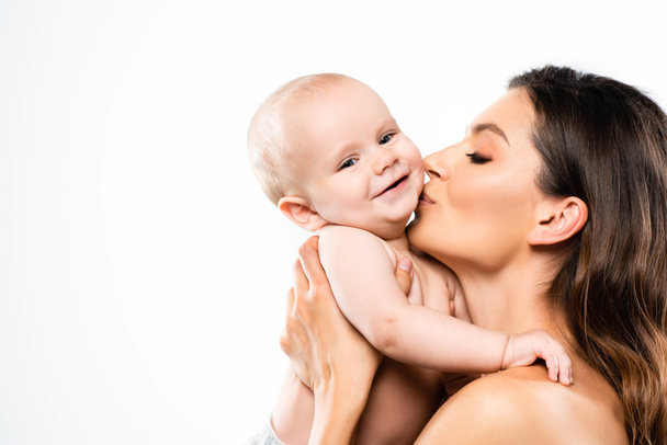portrait of naked mother kissing cute baby, isolated on white - Valokuva, kuva