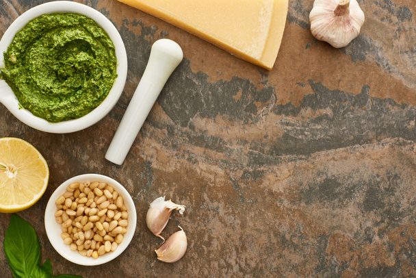 top view of pesto sauce and ingredients on stone surface - Foto, immagini