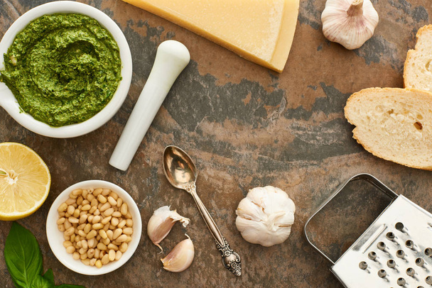 top view of pesto sauce, ingredients and bread on stone surface - Foto, immagini