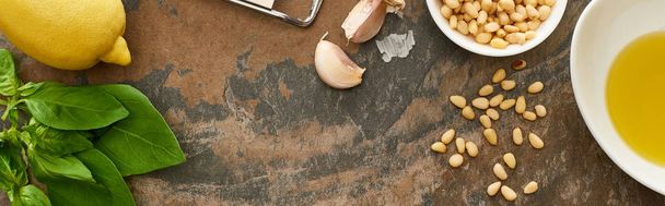 vista superior de ingredientes de molho pesto e ralador na superfície de pedra, tiro panorâmico
 - Foto, Imagem