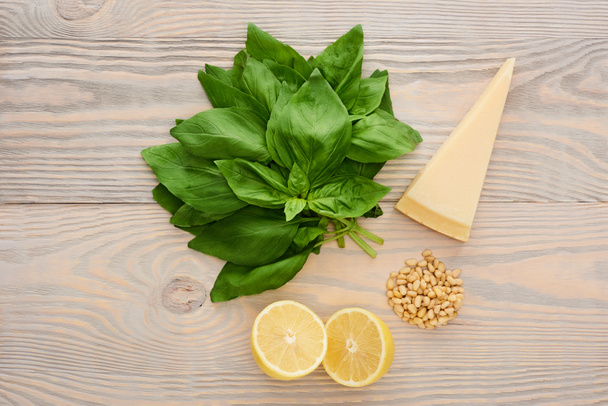 top view of pesto sauce raw ingredients on wooden table - Photo, Image