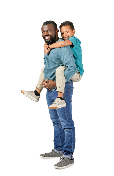 Portrait of African-American man with his little son on light background - Foto, imagen