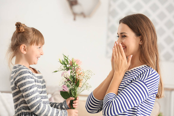 Little girl greeting her mother at home - Fotó, kép