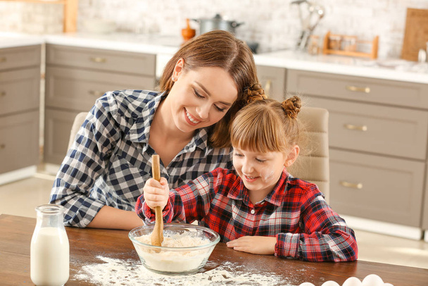 Mutlu anne ve kız evde pasta pişiriyor. - Fotoğraf, Görsel