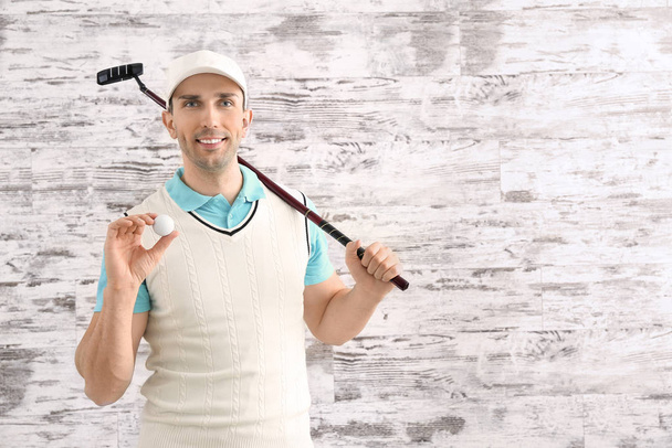 Handsome male golfer on wooden background - Photo, Image