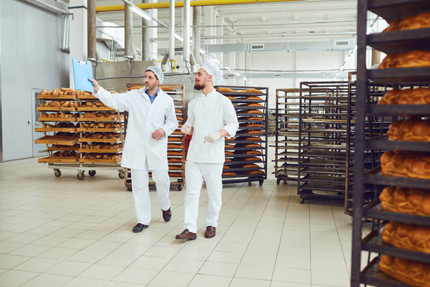The technologist and baker speak in a bread factory. - Foto, Imagem