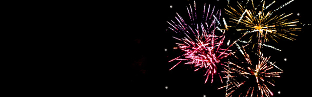 panoramic shot of colorful festive fireworks in night sky, isolated on black - Photo, Image