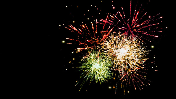 πολύχρωμα εορταστικά πυροτεχνήματα στο νυχτερινό ουρανό, απομονωμένα σε μαύρο - Φωτογραφία, εικόνα