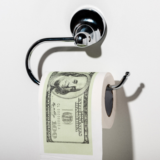 close up of toilet paper with dollar banknote on white  - Photo, Image