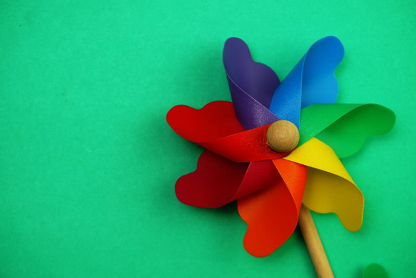 Colorful pinwheel with space copy isolated on green background - Foto, Imagem