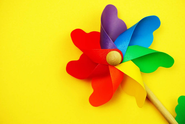 Colorful pinwheel with space copy isolated on yellow background - Fotografie, Obrázek