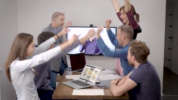 ομάδα των εργαζομένων γραφείου επικοινωνούν με το αφεντικό με βιντεοκλήση, πανηγυρίζοντας, γιορτάζοντας μια νίκη στην αίθουσα συνεδριάσεων - Πλάνα, βίντεο