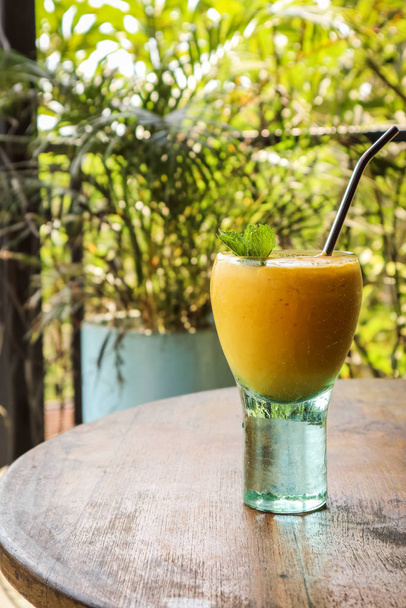 Mango juice in glass  - Фото, изображение