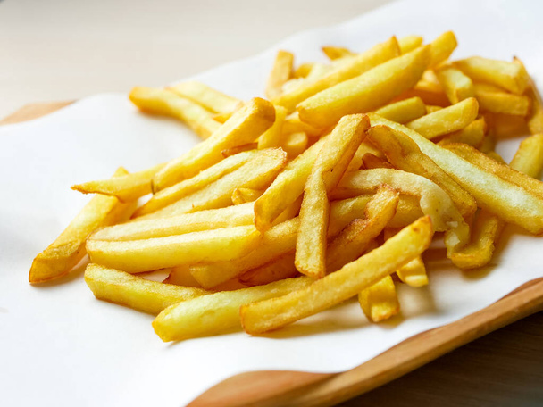 close-up view of tasty french fries on restaurant table - Foto, imagen