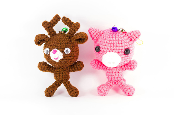 crochê artesanal veado marrom e boneca de porco rosa no backgroun branco
 - Foto, Imagem