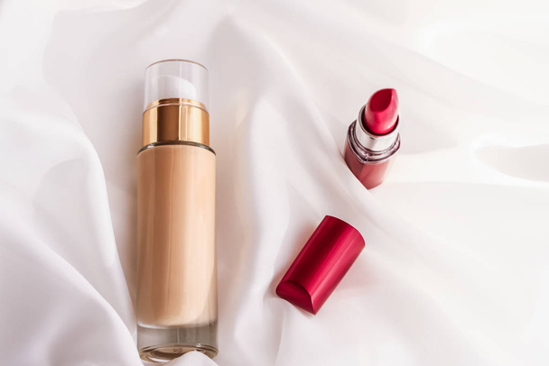 Бежевая тональная бутылка крема макияж основания жидкости и красный л
 - Фото, изображение