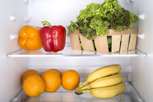 Open fridge full of fresh fruits and vegetables - Fotoğraf, Görsel