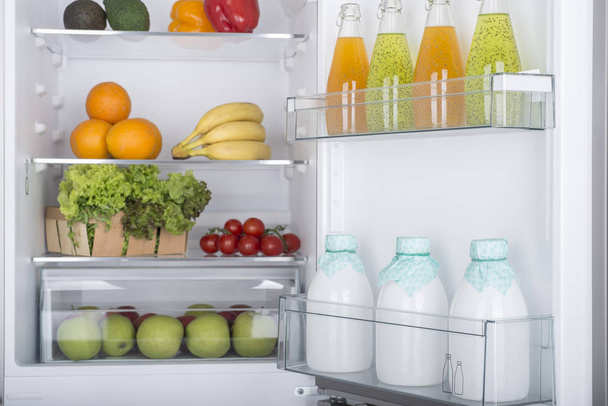 Open fridge full of fresh fruits and vegetables - Foto, Imagen