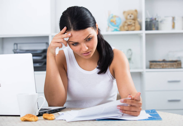 Sad woman working with documents - Фото, изображение