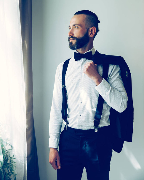 portrait of a handsome groom in a wedding suit. - Zdjęcie, obraz