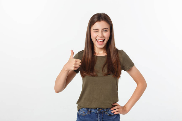 Closeup portrait of a beautiful young woman showing thumbs up sign. Isolate over white background. - Fotoğraf, Görsel