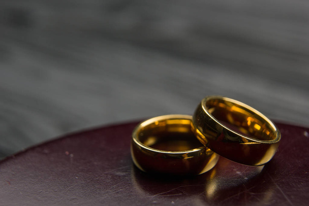 Concepto de divorcio y separación. Dos anillos de boda dorados, martillo de juez
. - Foto, Imagen