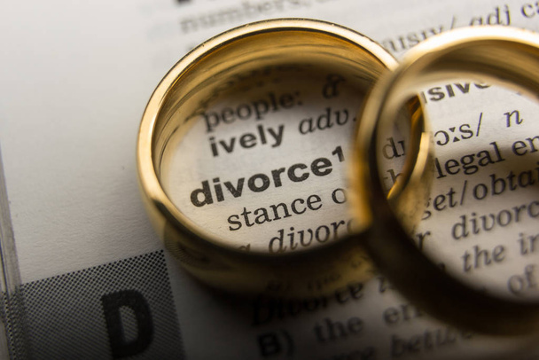 Divorce and separation concept. Two golden wedding rings. Dictionary definition - Fotó, kép