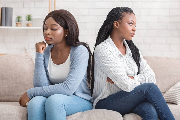 Offended girlfriends sitting back to back, ignoring each other after quarrel - Photo, Image