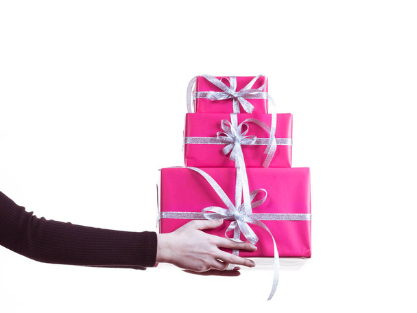 Female hands holding stack of pink gift boxes - Foto, Bild