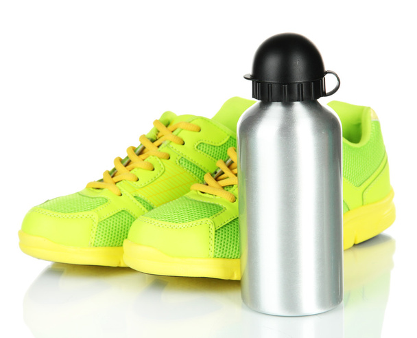 Sports bottle and sneakers isolated on white - 写真・画像