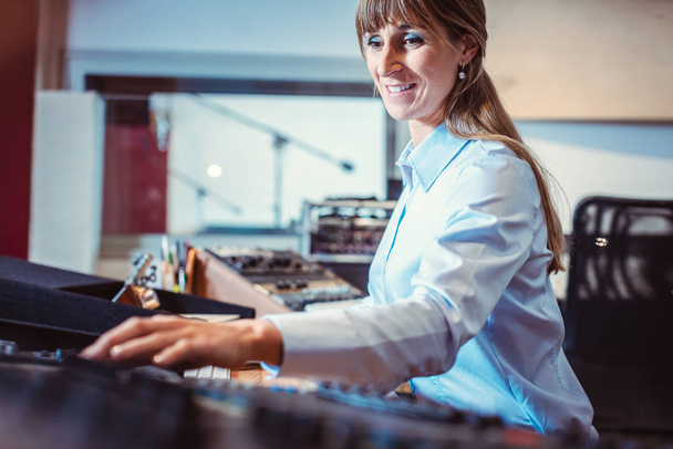 Sound engineer woman at the mixing console - Φωτογραφία, εικόνα