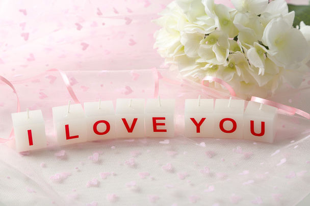 Candles with printed sign I LOVE YOU,on light background - Foto, Imagen