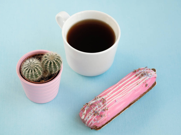 cup coffee and eclair and cactus in pot , close view, breakfast concept  - Fotografie, Obrázek