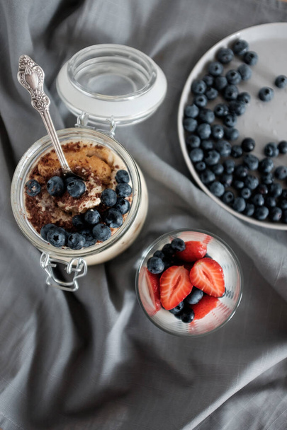 Healthy yogurt for breakfast with blueberries and strawberries - Photo, image
