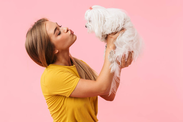 Beautiful lovely girl holding her pet lapdog - Foto, Imagen