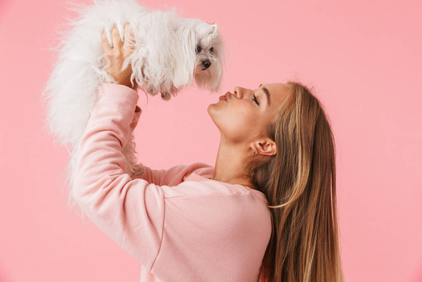 Beautiful lovely girl holding her pet lapdog - Fotoğraf, Görsel