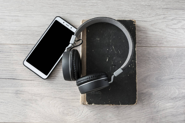headphones, smartphone and open blank book on wooden table. Top  - Photo, Image