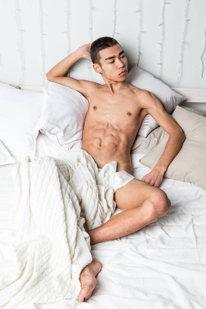 Young handsome man rest in bed. Sexy naked guy is resting - Foto, Bild